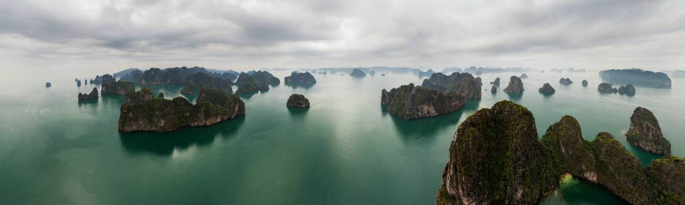 Thousands of limestone dragons into the sea surface in Halong