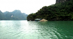Fishing house between the emerald seas of Halong Bay in your North Vietnam Travel.