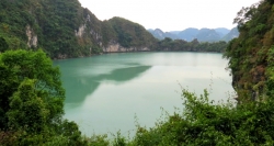 An emerald lake that you can see from the peak of Maze Cave