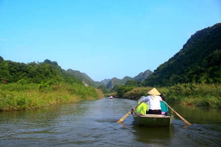 Your boat rows along the narrow canals from King Le Port to Tam Coc Port