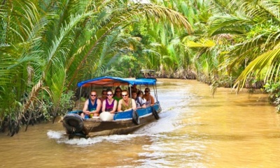 Go along the narrow canals of Cuu Long Delta by boat.