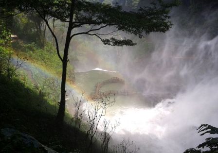 a rainbow is adoring the imposing looking of Dambri waterfalls.