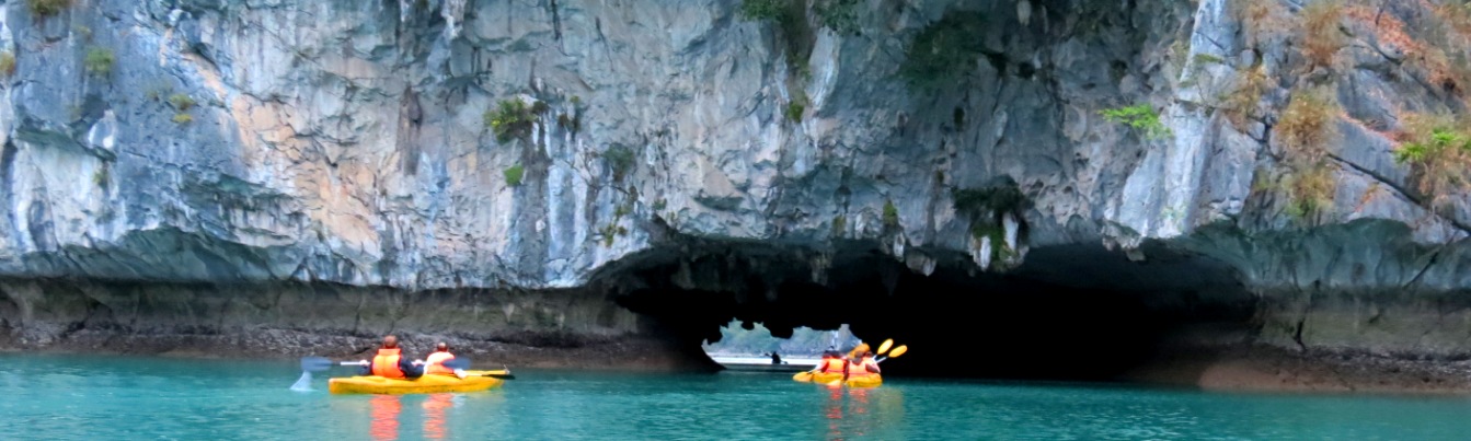 Go kayaking in the area of Bright and Dark Cave with Orchid Cruise Halong