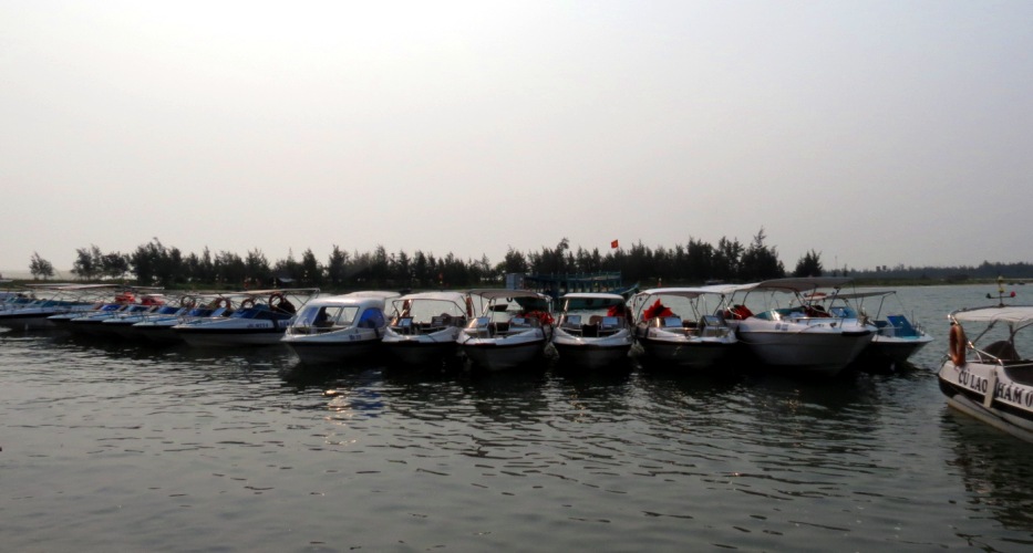 Cua Dai wharf with lots of canoes which are willing to take you to Cham Island