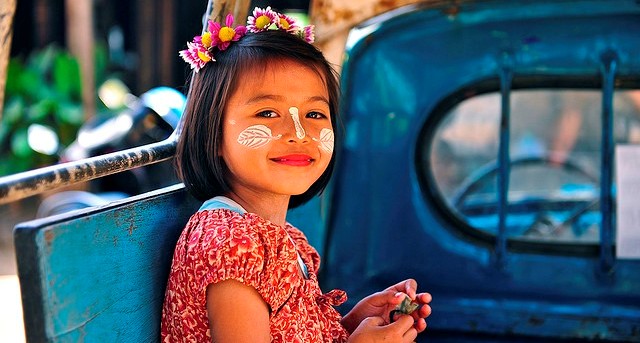 Burmese baby girl looks like a doll with some thanakha in her face.